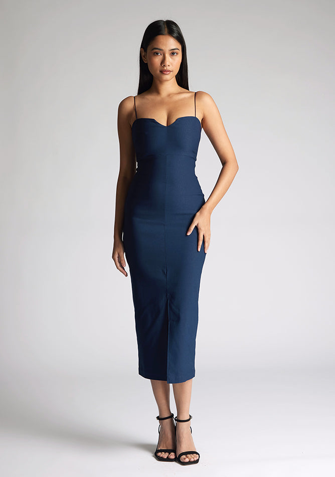 Front image of model wearing a navy strappy midaxi dress with a sweetheart neckline, thin straps, centre front skirt split and centre back zip for a perfect fit. The design featured is the Vesper Miren Navy Strappy Midaxi Dress