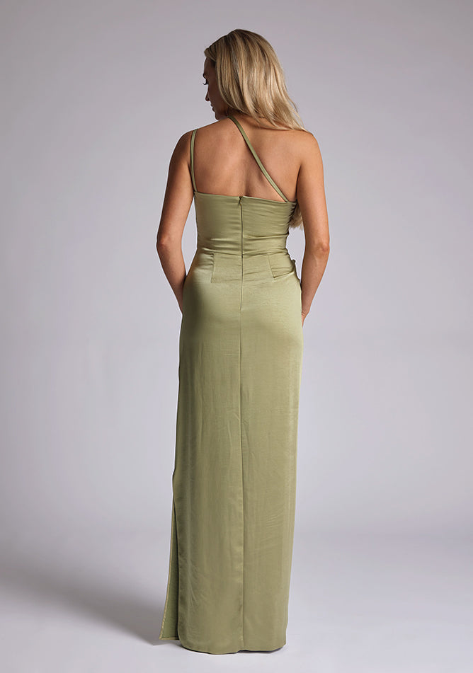 Back image of a model wearing an olive satin maxi dress with a cross strap detail, pleats detailing at the front bust and delicate side skirt split. The design featured is the Vesper Solange Olive Satin Maxi Dress