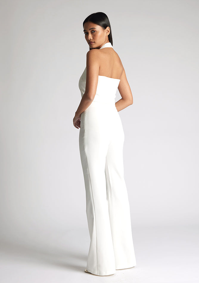 Back quarter image of model wearing a ivory wide leg trousers with a flattering high waist and wide leg design. The design featured is the Vesper Connie Ivory Wide Leg Trousers paired with Vesper Eve Ivory Waistcoat