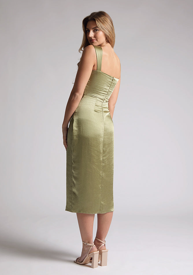 Back quarter image of a model wearing olive satin midaxi dress with a sweetheart neckline, wide comfy straps and front skirt split. The dress featured is the Vesper Desiree Olive Satin Midaxi Dress