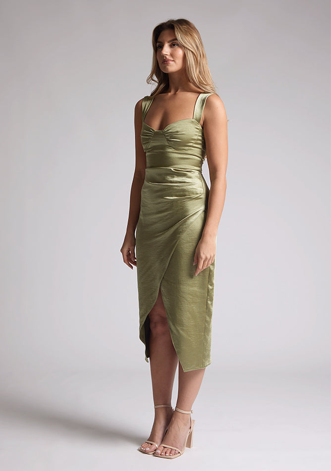 Front quarter image of a model wearing olive satin midaxi dress with a sweetheart neckline, wide comfy straps and front skirt split. The dress featured is the Vesper Desiree Olive Satin Midaxi Dress