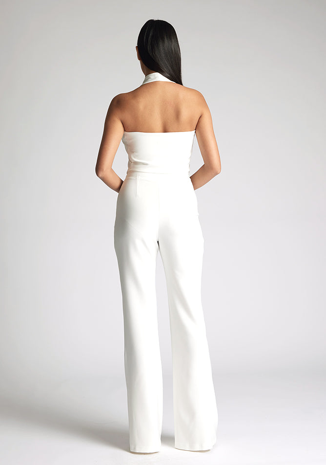Back image of a model wearing a ivory waistcoat with a chic, sophisticated and sleeveless halter-neck waistcoat top. The design featured is the Vesper Eve Ivory Waistcoat paired with Vesper Connie Ivory Wide Leg Trousers