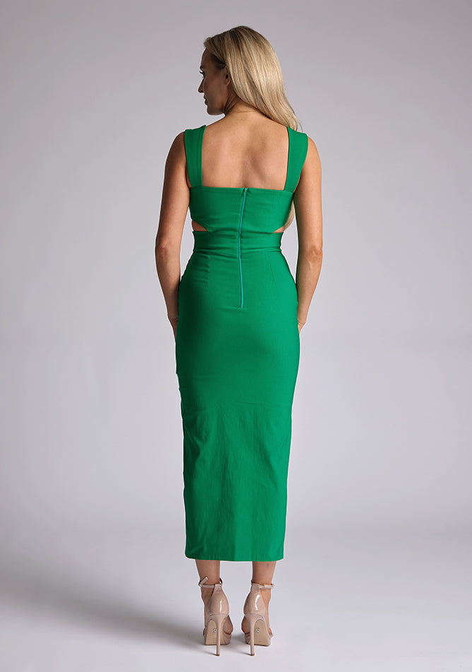 Back image of a model wearing a green cut out midaxi dress with a sweetheart neckline with wide straps, a side cut-out and front skirt split. The design featured is the Vesper Porticini Emerald Green Cut Out Midaxi Dress