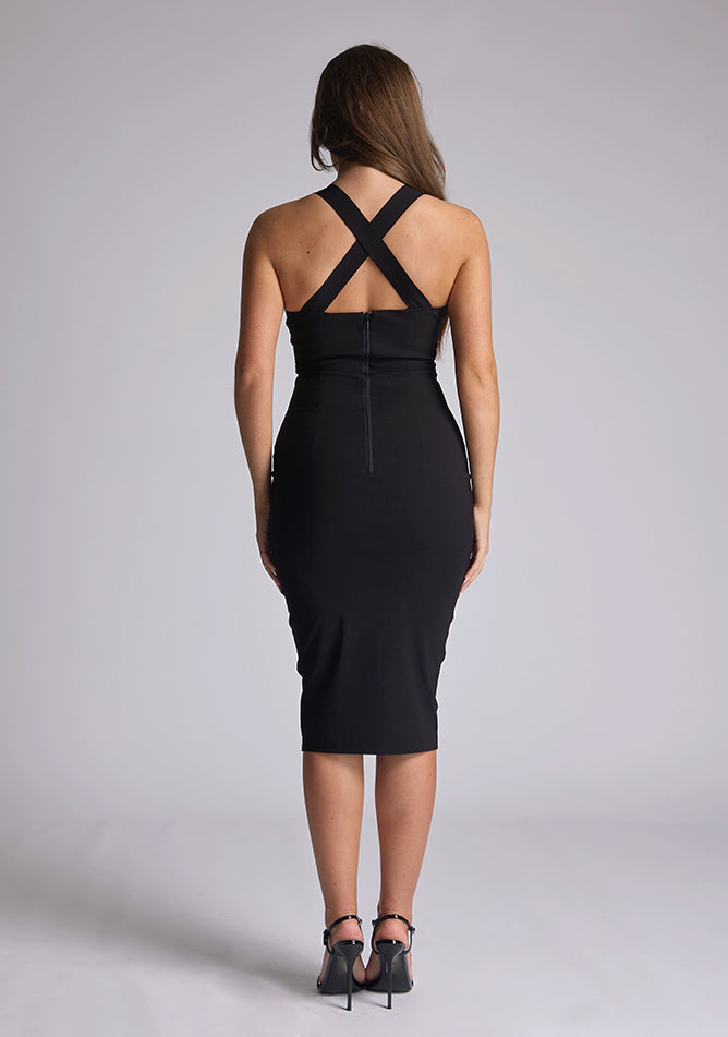 Back image of a blonde model wearing a black sweetheart plunge midi dress with a plunge neckline with cross back detail and a slim fit. The design featured is the Vesper Sian Black Sweetheart Plunge Midi Dress