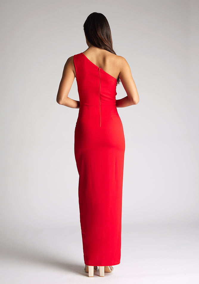 Back image of model wearing red asymmetric maxi dress with a asymmetric neckline with one shoulder detail, front bodice cut-out and front skirt split. The design featured is Vesper Verity Red Asymmetric Maxi Dress