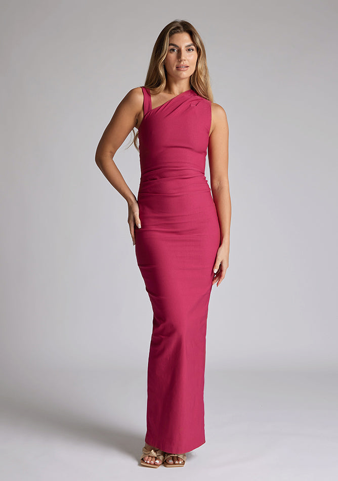Front image of a model wearing a raspberry asymmetric maxi dress with a asymmetric neckline silhouette, back skirt split and ruched detailing enhances the dress's allure. The design featured is the Vesper Wyatt Raspberry Asymmetric Maxi Dress