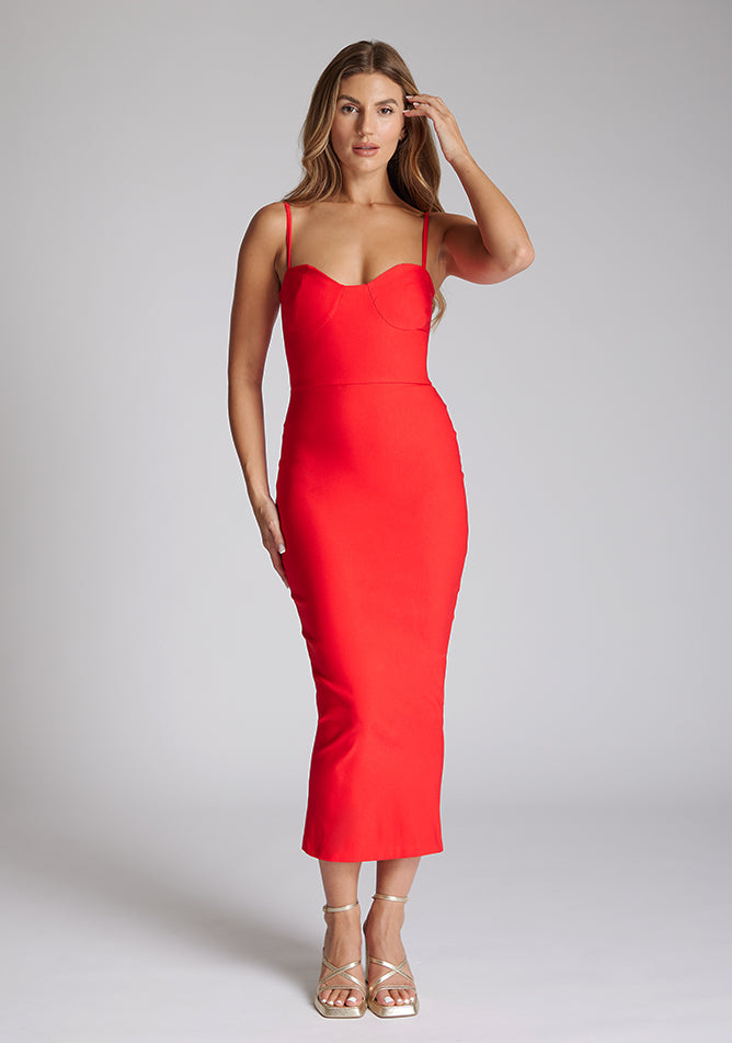 Front image of the model wearing a red midaxi dress with a sweetheart neckline that accentuates your neckline beautifully, bodycon fit and centre gold back zip. The design featured is the Vesper Zoya Red Midaxi Dress