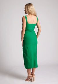 Back quarter image of the model wearing a emerald body con midaxi dress with a square neckline and a front split. The design featured is the Vesper Abbie Emerald Midaxi Dress