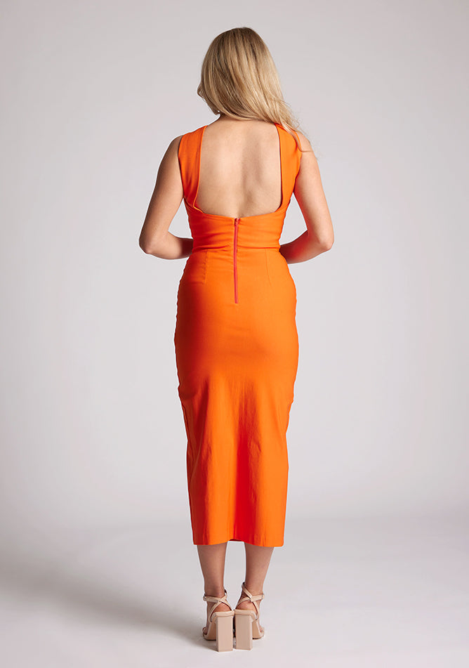 Back image of a model wearing a Orange Cross Neck Midaxi Dress with a crossover neck detail with flattering open back, and a high leg split, a design features Vesper Aida Orange Cross Neck Midaxi Dress
