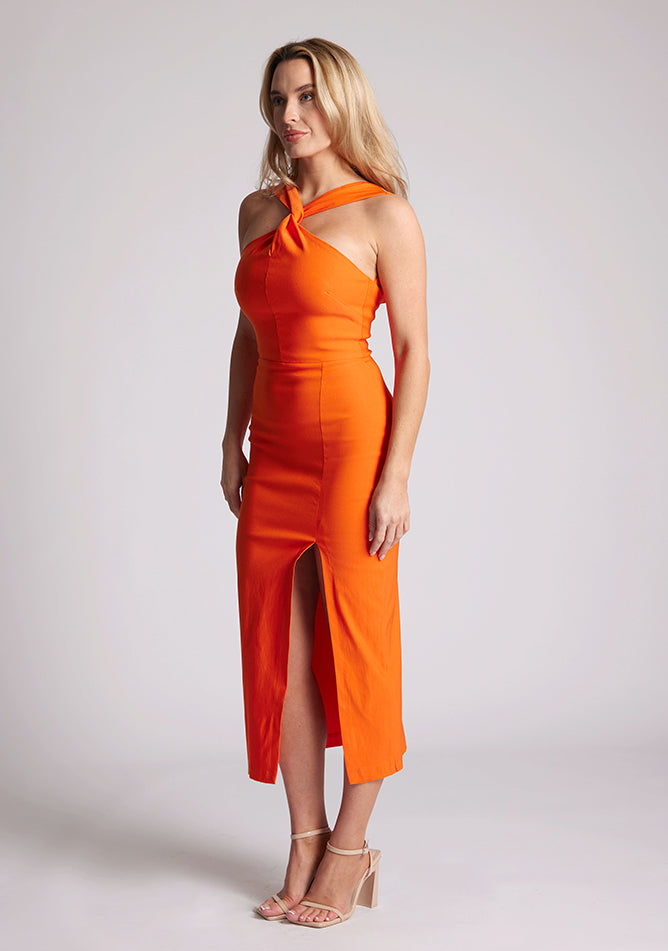 Quarter Side image of a model wearing a Orange Cross Neck Midaxi Dress with a crossover neck detail with flattering open back, and a high leg split, a design features Vesper Aida Orange Cross Neck Midaxi Dress