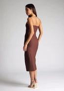 Quarter back image of the model wearing a Chocolate Midaxi Dress with a straight-across neckline and delicate thin straps, and a front skirt split, a design features Vesper Alyssa Chocolate Midaxi Dress