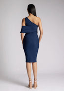 Back image of a model wearing a navy midi dress, featuring an asymmetric neckline, one shoulder detail and statement band around one arm. The dress featured is the Vesper Amos Navy Midi Dress.