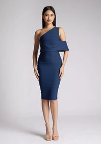 Front image of a model wearing a navy midi dress, featuring an asymmetric neckline, one shoulder detail and statement band around one arm. The dress featured is the Vesper Amos Navy Midi Dress.