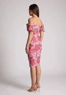 Quarter back image of a model wearing a floral bardot dress, featuring puff sleeves and a midi length. The dress featured is the Anastasia Pink Floral Bardot Midi Dress