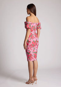 Quarter back image of a model wearing a floral bardot dress, featuring puff sleeves and a midi length. The dress featured is the Anastasia Pink Floral Bardot Midi Dress