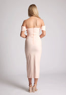 Back image of a model wearing a primrose bardot dress, with a front split. The dress featured is the Astra primrose bardot midaxi dress