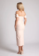 Quarter back image of a model wearing a primrose bardot dress, with a front split. The dress featured is the Astra primrose bardot midaxi dress