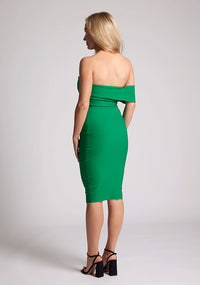 Back quarter image of a model wearing a emerald midi dress with a strap across the chest around one arm. The dress featured is the Vesper Beck emerald midi dress