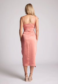 Back image of a model wearing a peach Midaxi Dress with a sweetheart neckline with a spaghetti strap, a wrap-bust style, and a wrap skirt detail, a design features Brooklyn Peach Midaxi Dress