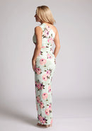 Back quarter image of a model wearing a floral maxi dress with one shoulder. The dress featured is the Charlotte mint floral maxi dress