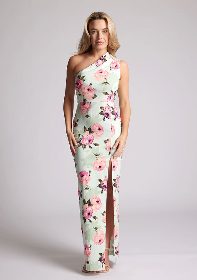 Front image of a model wearing a floral maxi dress with one shoulder. The dress featured is the Charlotte mint floral maxi dress