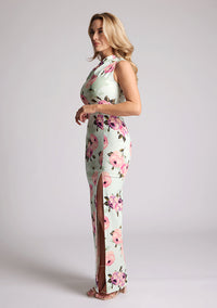 Front quarter image of a model wearing a floral maxi dress with one shoulder. The dress featured is the Charlotte mint floral maxi dress