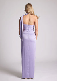 Back  image of a model wearing a lilac maxi evening dress with asymmetric neckline, front skirt split and statement collar drape detail, item featured is Vesper Cordula Lilac Collar Detail Maxi Dress