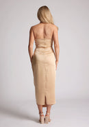Back image of a model wearing a champagne satin midaxi dress featuring a halter neck and a ruched design. The dress featured is the Vesper Electra champagne satin midaxi dress