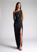 Front image of the model wearing a Black Maxi Dress with a one-shoulder design with a front cut-out, and a front skirt split, a design features Vesper Ellis Black Maxi Dress