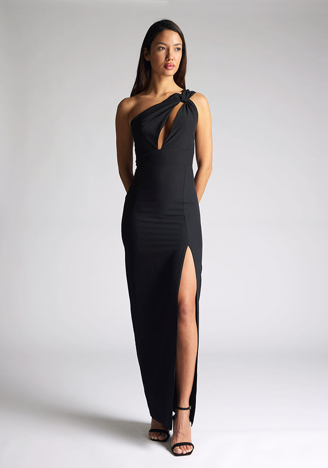 Front image of the model wearing a Black Maxi Dress with a one-shoulder design with a front cut-out, and a front skirt split, a design features Vesper Ellis Black Maxi Dress