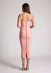 Back image of a model wearing a peach midaxi dress with a cut out under the bust. The dress featured is the Frances peach midaxi dress