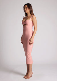 Front quarter image of a model wearing a peach midaxi dress with a cut out under the bust. The dress featured is the Frances peach midaxi dress