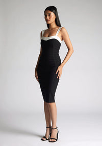 Front quarter image of the model wearing a Monochrome Midi Dress with a square neckline with wide straps, and a bodycon fit, a design features Vesper Kylin Monochrome Midi Dress