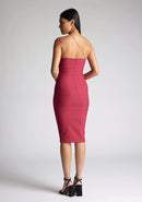 Back quarter image of the model wearing a Raspberry Midi Dress with a asymmetrical neckline with one strap, and a bodycon silhoutte, a design features Vesper Leslie Raspberry Midi Dress