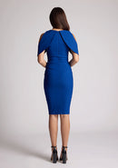Back image of a model wearing a cobalt midi dress featuring two open shoulder sleeves. The dress featured is the Vesper Lulu cobalt midi dress.