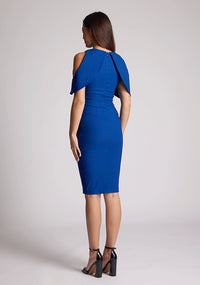 Back quarter image of a model wearing a cobalt midi dress featuring two open shoulder sleeves. The dress featured is the Vesper Lulu cobalt midi dress.