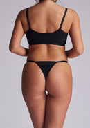 Back view of the Luxe Element Sapphire Triangle Thong revealing its minimal coverage, delicate strap detailing, and V-shaped satin panels for an elegant rear profile.