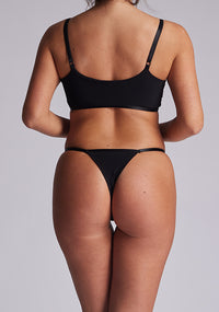Back view of the Luxe Element Sapphire Triangle Thong revealing its minimal coverage, delicate strap detailing, and V-shaped satin panels for an elegant rear profile.
