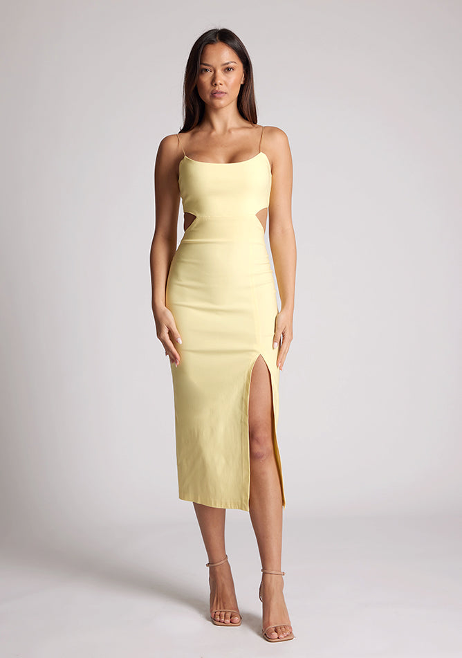 Front image of a model wearing a sherbert midi dress, featuring cut outs at the waist and a front split in the skirt. The dress featured is the Vesper Marilynn sherbert midaxi dress