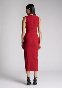 Back  image of a model wearing a wine midaxi dress, featuring a cut out at the front and asymmetric straps. The dress featured is the Vesper Queenie wine midaxi dress