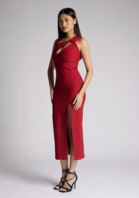 Front quarter  image of a model wearing a wine midaxi dress, featuring a cut out at the front and asymmetric straps. The dress featured is the Vesper Queenie wine midaxi dress