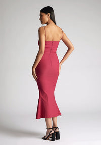 Back quarter image of the model wearing a Raspberry Midaxi Dress with a sweetheart neckline with a thin straps, and a slim fit, a design features Vesper Roisin Raspberry Midaxi Dress