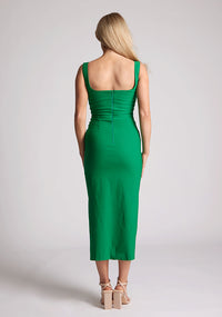 Back image of the model wearing a emerald bodycon midaxi dress with a square neckline and a front split. The design featured is the Vesper Abbie Emerald Midaxi Dress