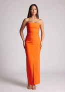 Front image of a model wearing an orange strapless maxi dress with a front split and centre back zip. The design featured is the Vesper Alaya Orange Bodycon Maxi Dress