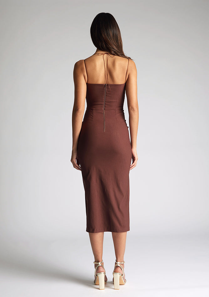 Back image of the  model wearing a Chocolate Midaxi Dress with a straight-across neckline and delicate thin straps, and a front skirt split. The design featured is the Vesper Alyssa Chocolate Midaxi Dress