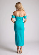 Back image of a model wearing a lake green bardot dress with a  stunning bardot neckline with armbands and a front skirt split. The design featured is the Vesper Astra lake Green Bardot Midaxi Dress