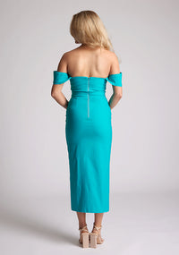 Back image of a model wearing a lake green bardot dress with a  stunning bardot neckline with armbands and a front skirt split. The design featured is the Vesper Astra lake Green Bardot Midaxi Dress