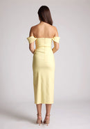 Back image of a model wearing a yellow bardot midaxi dress with a stunning bardot neckline with armbands and a front skirt split. The design featured is the Vesper Astra Yellow Bardot Midaxi Dress