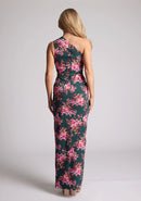 Back image of a model wearing a green floral maxi dress with a  asymmetric one-shoulder design, delicate pleats and front skirt split. The design featured is the Vesper Charlotte Green Floral Maxi Dress