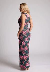 Back quarter image of a model wearing a green floral maxi dress with a  asymmetric one-shoulder design, delicate pleats and front skirt split. The design featured is the Vesper Charlotte Green Floral Maxi Dress